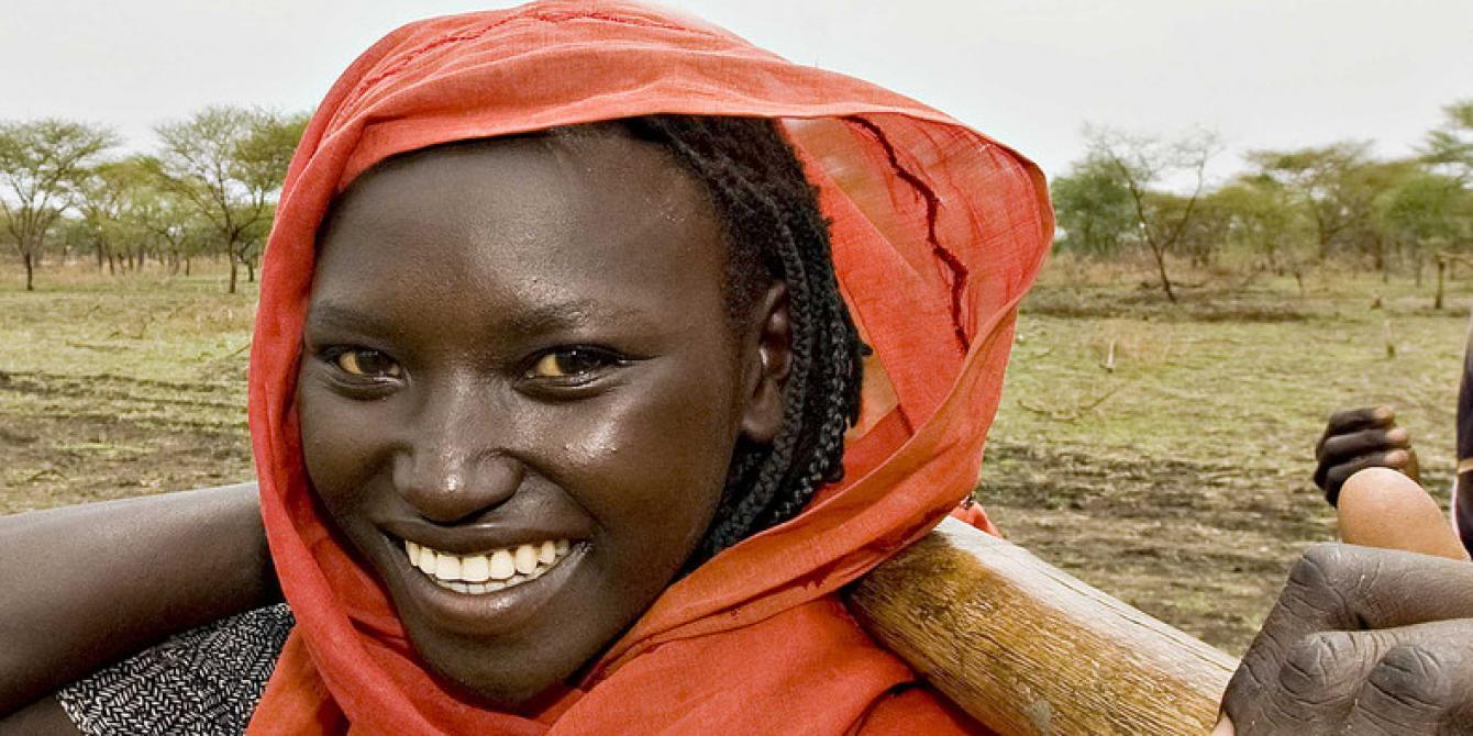 A farmer from South Sudan standing next to a newly cultivated land courtesy of the farm inputs support programme Pan Africa Programme Report 2016/2017